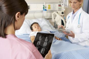 Nurse Using Digital Notepad Whilst Visiting Child Patient