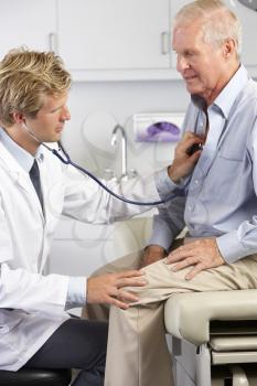 Doctor Listening To Male Patient's Chest