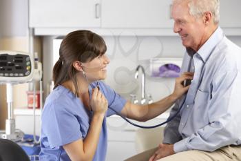 Doctor Listening To Male Patient's Chest