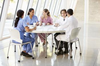 Medical Staff Chatting In Modern Hospital Canteen