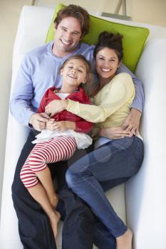 Overhead View Of Family Relaxing On Sofa