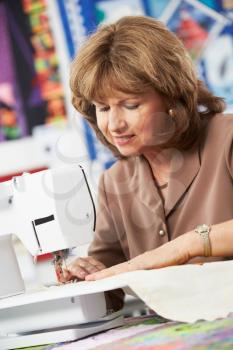 Woman Using Electric Sewing Machine