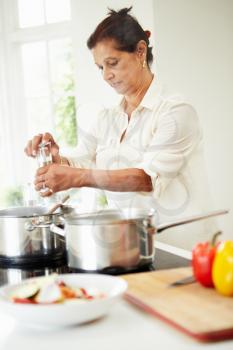 Senior Indian Woman Cooking Meal At Home