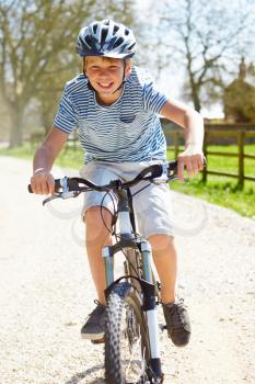 Young Boy Riding Bike Along Country Track