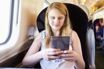Teenage Girl Reading E Book On Train Journey