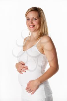 Studio Portrait Of 4 months pregnant Woman Wearing White