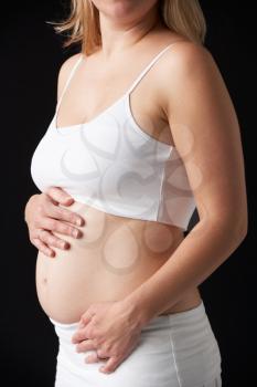 Close Up Portrait Of 4 months Pregnant Woman On Black Background