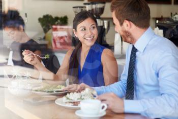 Two Businesspeople Meeting For Lunch In Coffee Shop
