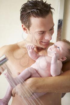 Father Taking Shower With Baby Daughter