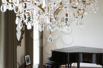 Room In Modern House With Chandelier And Grand Piano