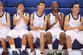 Members Of Male High School Basketball Team Watching Match
