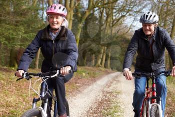 Senior Couple On Cycle Ride In Winter Countryside