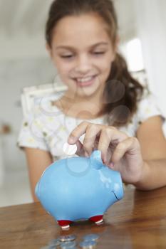 Young girl with piggy bank