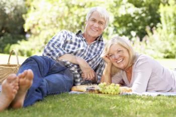 Senior couple with picnic in park