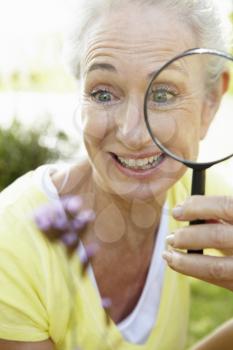 Senior woman with magnifying glass