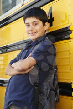 Pre teen boy with school bus