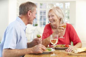 Retired couple enjoying meal at home