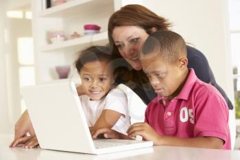 Mother and Downs Syndrome son with laptop