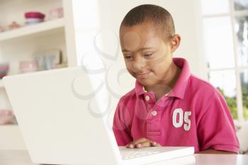 Downs Syndrome boy with laptop