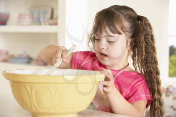 Girl with Downs Syndrome baking