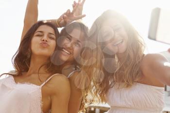 Three Teenage Girls Dancing And Taking Selfie