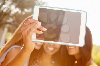 Female Friends On Holiday Taking Selfie With Digital Tablet