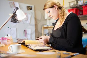 Young Woman Scrapbooking At Home