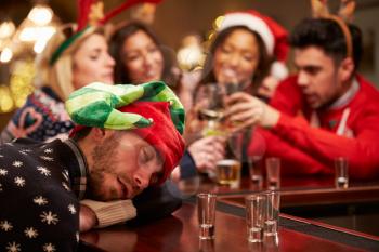 Man Passed Out On Bar During Christmas Drinks With Friends