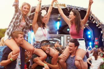 Friends having fun in the crowd at a music festival