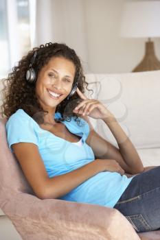 Young Woman Relaxing Listening To Music At Home