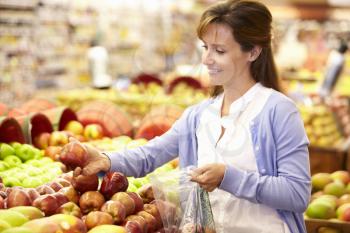 Woman buying fruit in supermarket