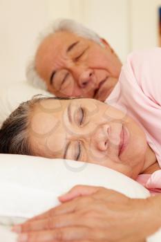 Senior Taiwanese couple sleeping