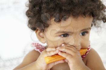 Young Girl Eating Carrot Stick