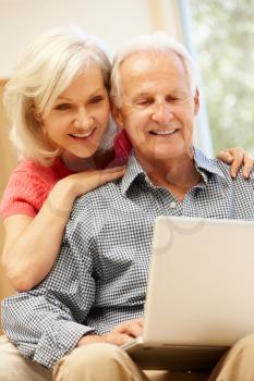 Senior man and daughter using laptop