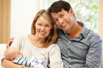 Couple at home with new baby