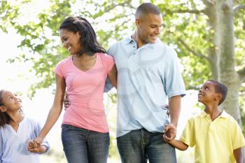 Young African American Family Enjoying Walk In Park