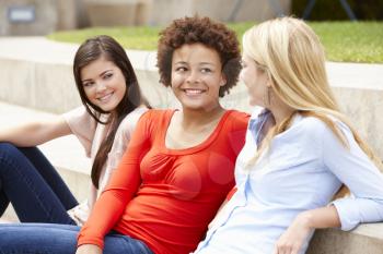 Teenage student girls chatting outdoors