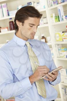 UK pharmacist in pharmacy with prescription