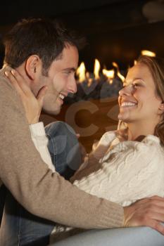 Romantic portrait couple in front of fire