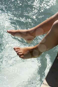 Young Girl's Feet Dangling Over Water