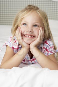 Young Girl Lying On Bed Smiling