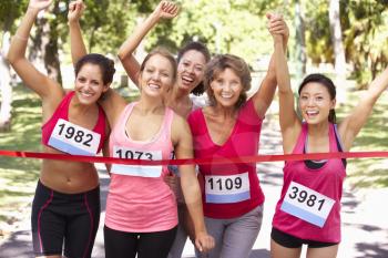Group Of Female Athletes Completing  Charity Marathon Race