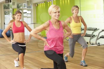 Women Taking Part In Gym Fitness Class