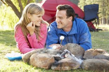 Couple Toasting Marshmallows Over Fire Camping Holiday