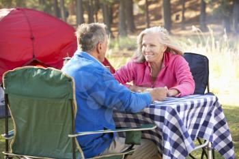 Senior Couple Enjoying Meal On Camping Holiday