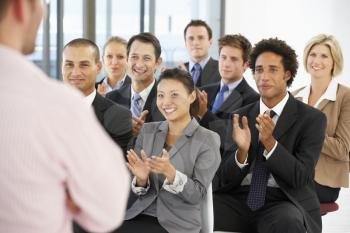 Group Of Business People Applauding Speaker At The End Of A Presentation
