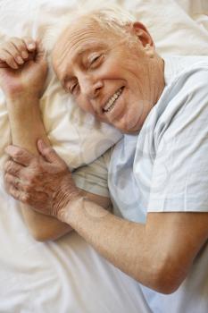 Senior Man Relaxing In Bed