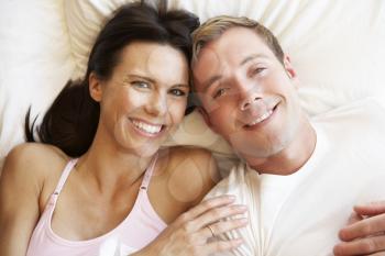 Couple Relaxing In Bed