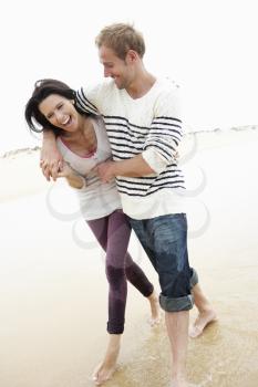 Couple Walking Along Beach Together