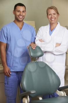 Portrait Of Dentist And Dental Nurse In Surgery